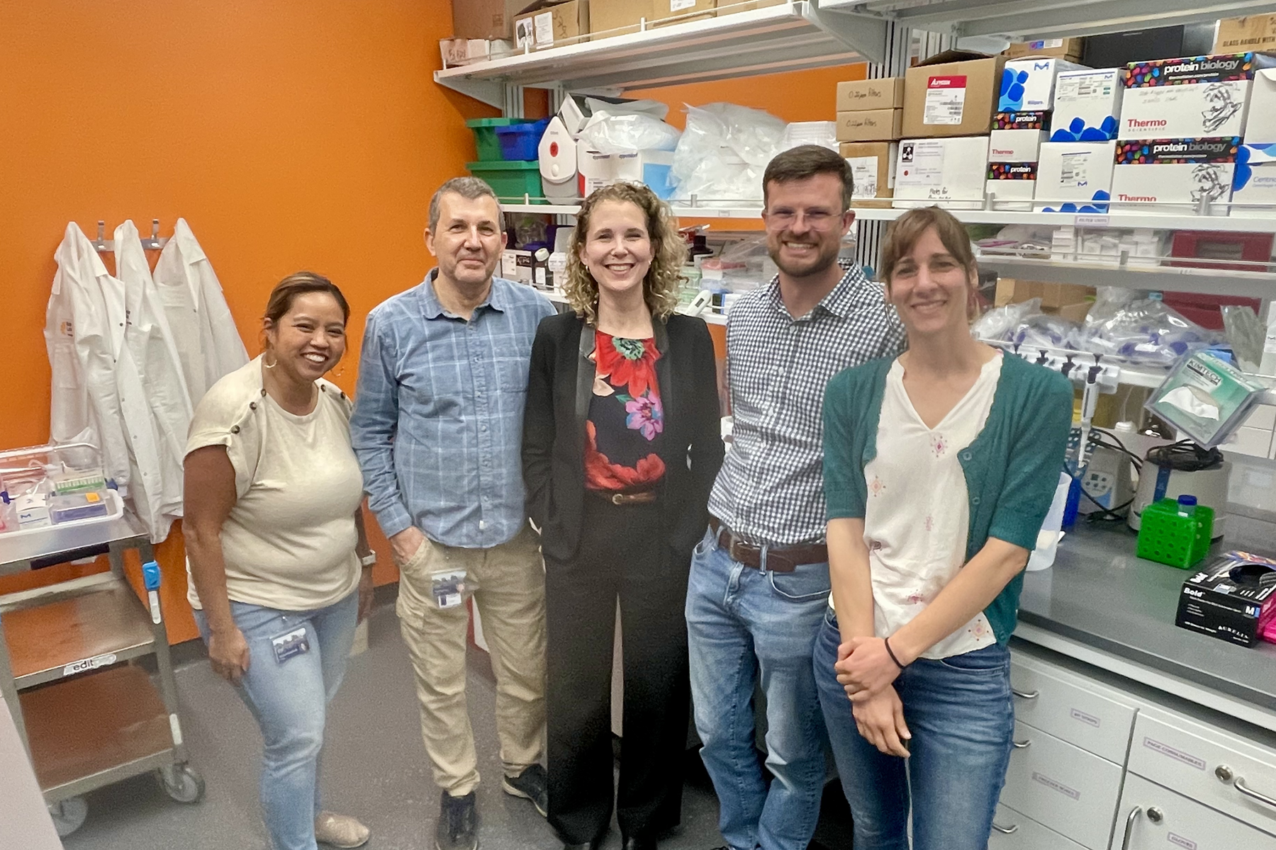 Five people standing in a lab