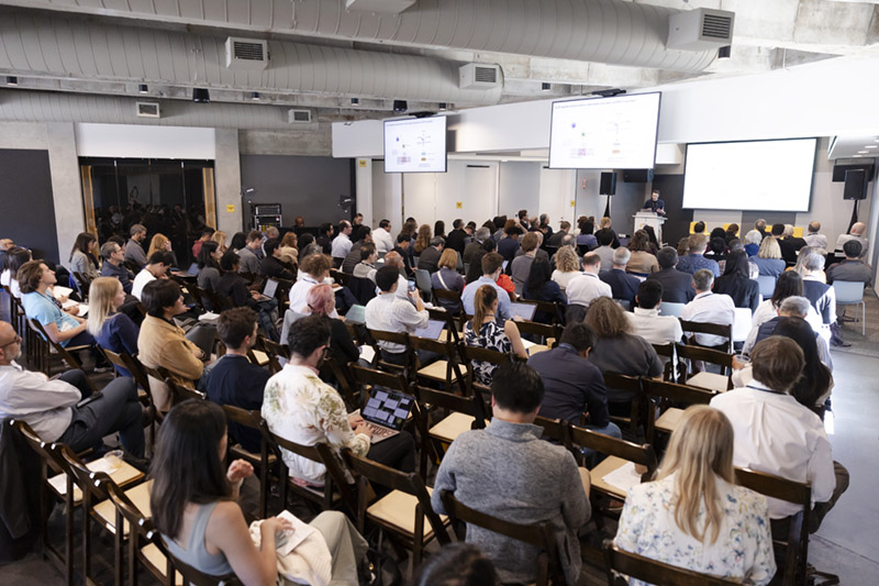 Auditorium full of people with presenter at front. Photo from 2025 QB3 symposium on autoimmune disease